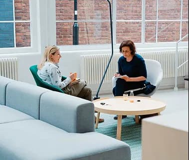 Colleagues talking through a resolution in a lounge