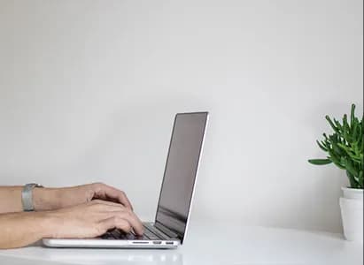 Hands typing a case response on a laptop