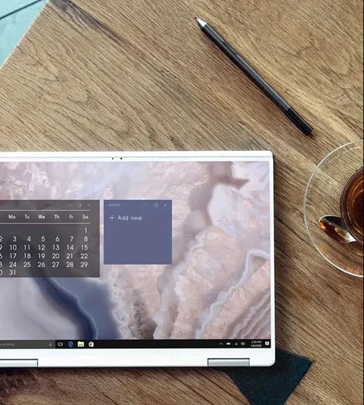 A milestone review open on a laptop beside a cup of tea