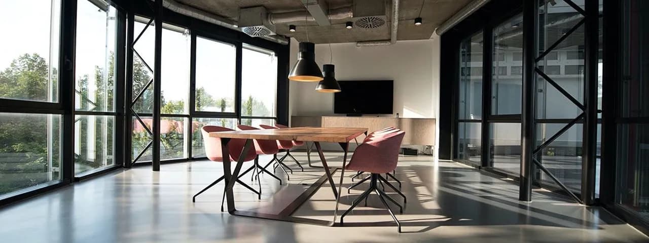 An open-plan office with teams working across regions