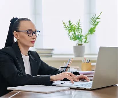 A professional reviewing payment dependencies at a laptop