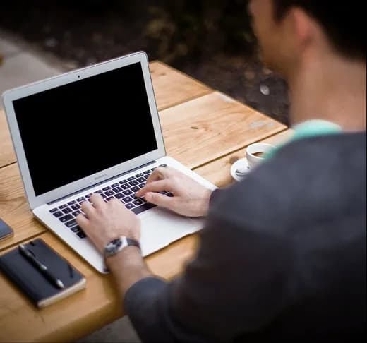 A record open on a laptop on a desk